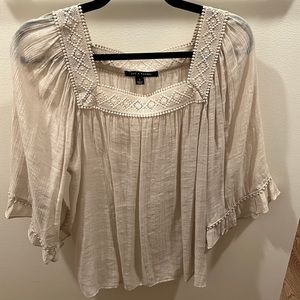 Flowy blouse with square neck and large sleeves. Cute crochet detail at neckline